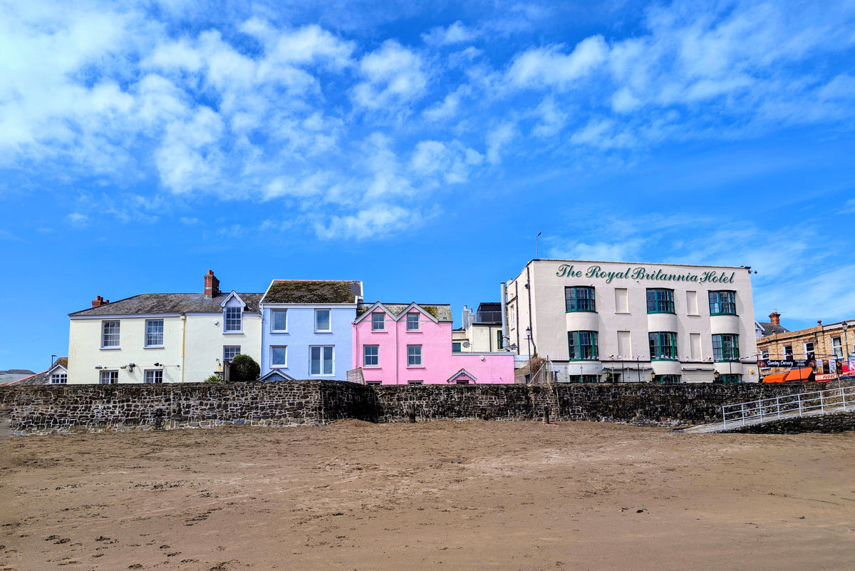 Eco canvas print of seaside buildings with blue sky and pink storefronts