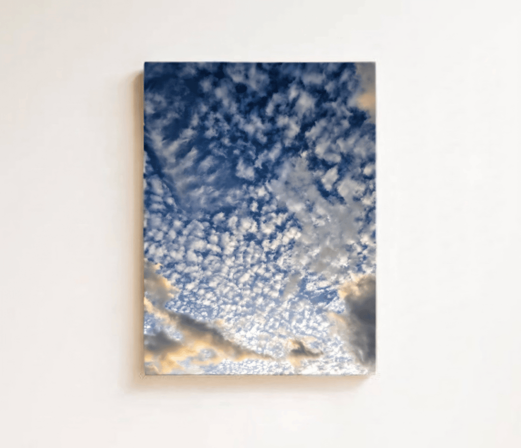 Stretched canvas print: blue cloudy sky with golden highlights, square wall art