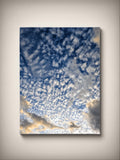 Stretched canvas print: blue cloudscape with bright golden glow, vertical square wall art