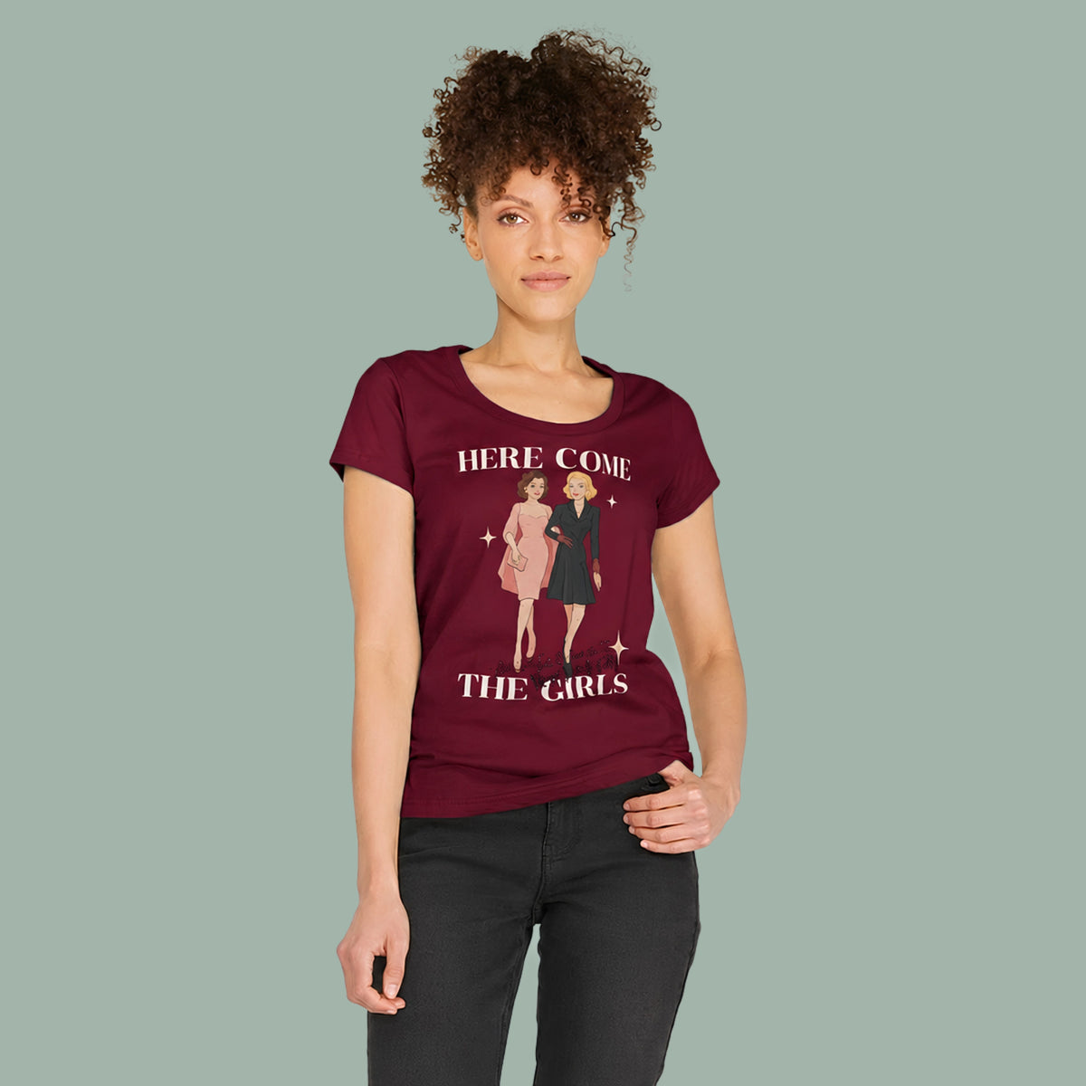Women’s fitted burgundy T-shirt with 'HERE COME THE GIRLS' graphic and two-girl print