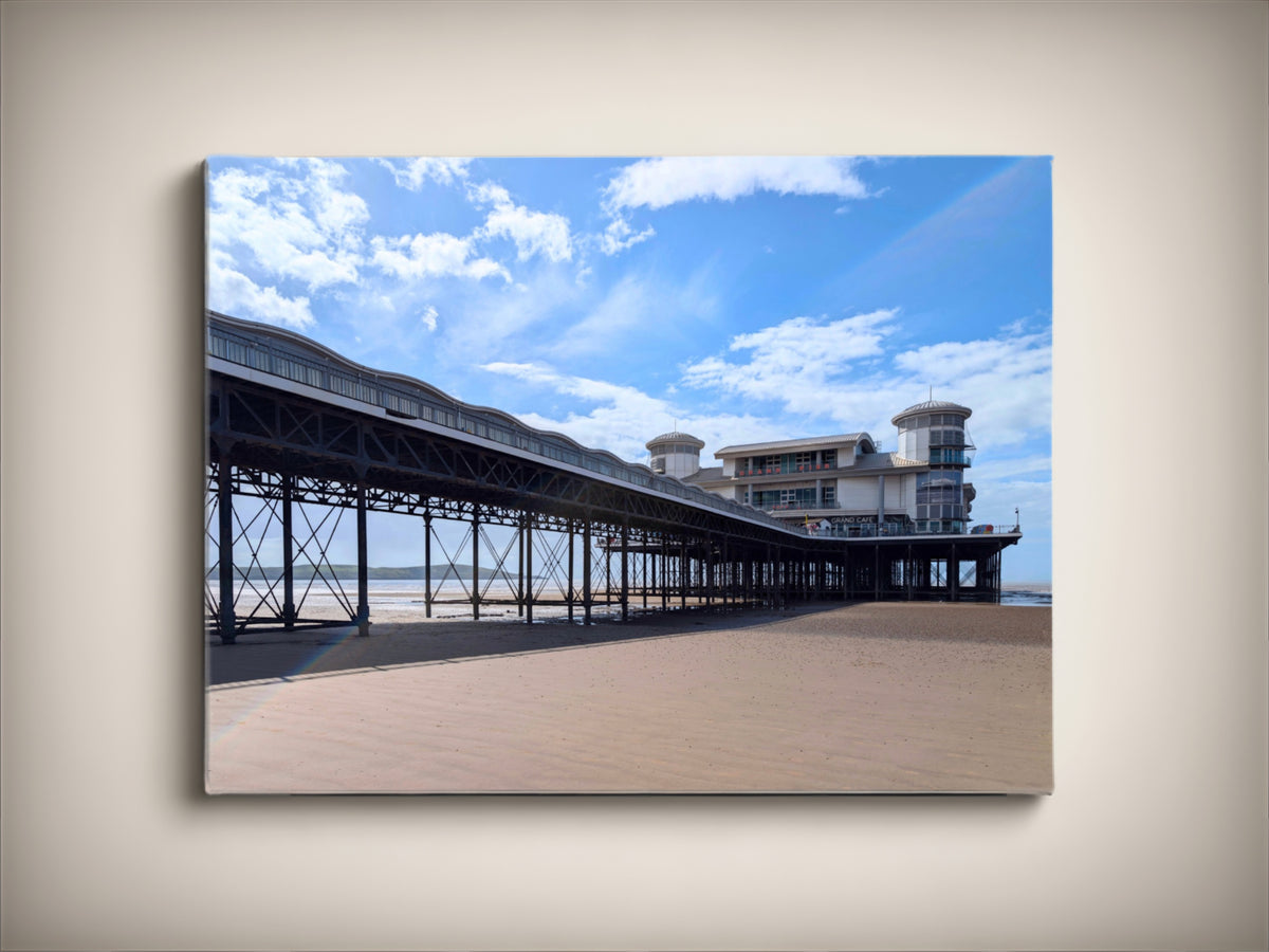 Stretched canvas print of a seaside pier under a blue sky with clouds.