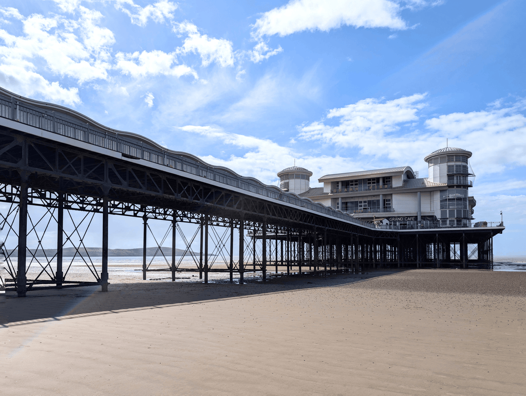 Stretched canvas print of a seaside pier with railings under a blue sky