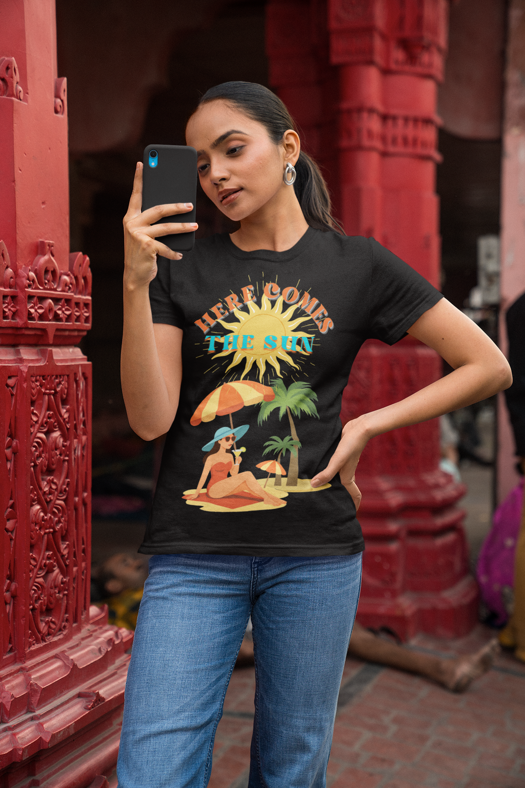Here Comes the Sun T-shirt Gildan SoftStyle ladies fitted T-shirt. Lady wearing Here Comes the Sun design, ringspun cotton, black, front view