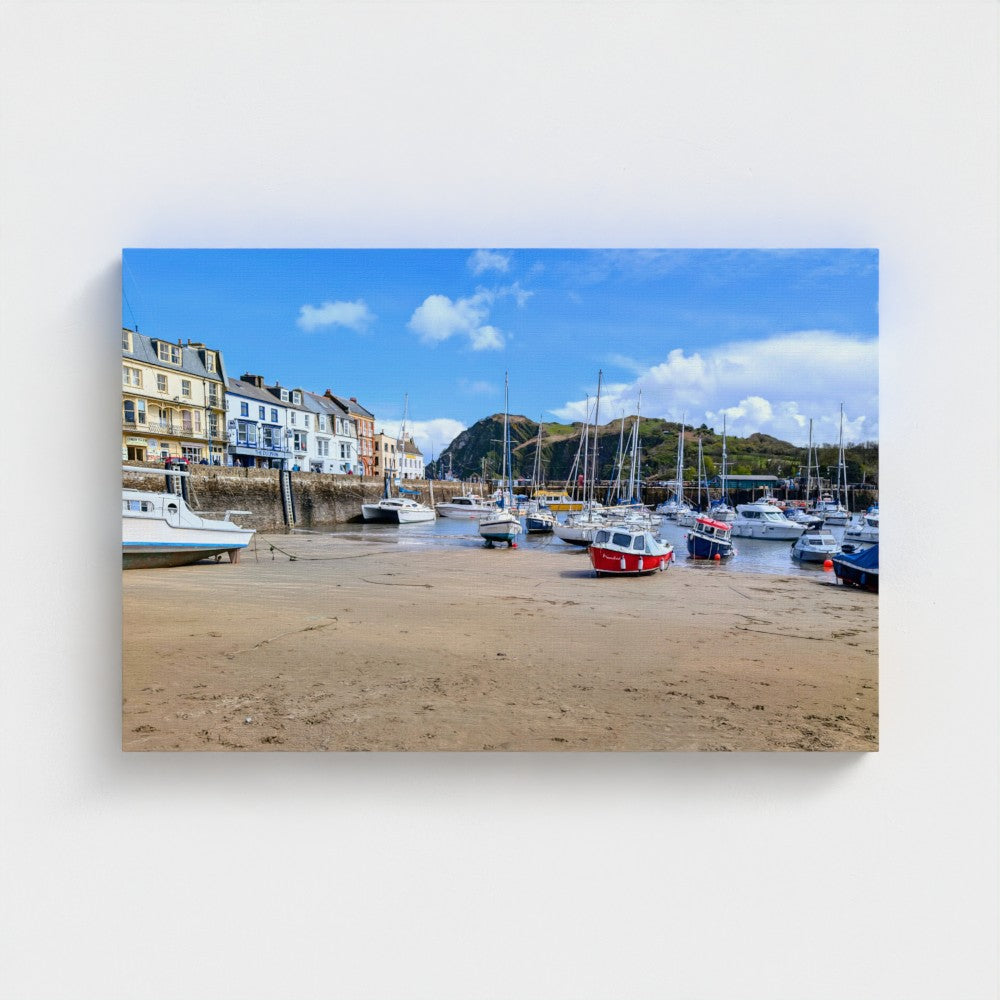 Eco canvas print of red-and-white boats at low tide in a harbor